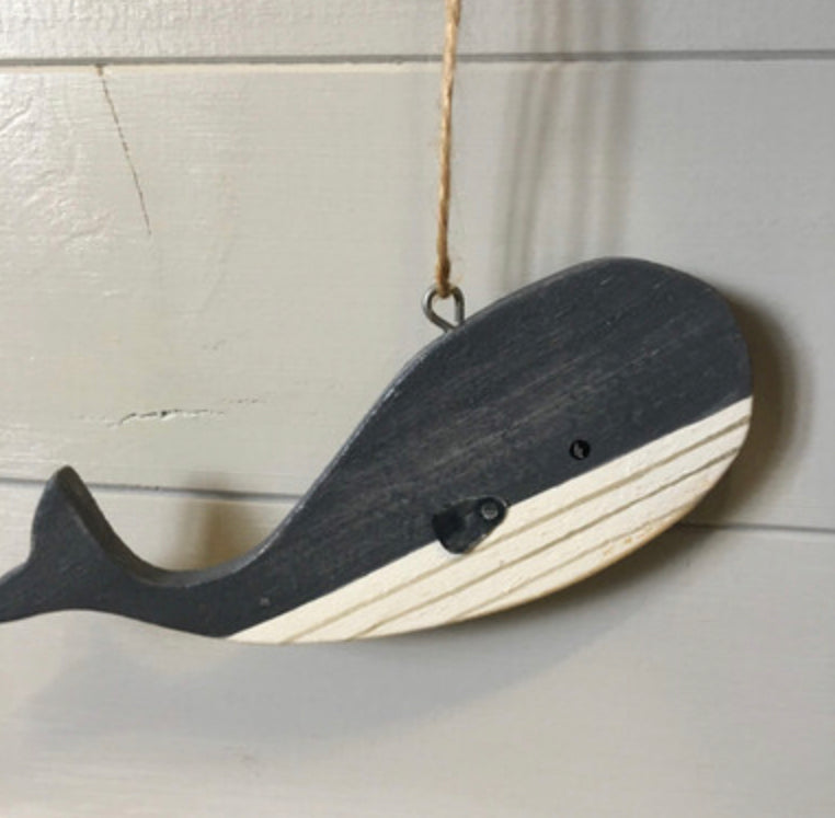 Hanging blue wooden blue whales by Shoeless Joe