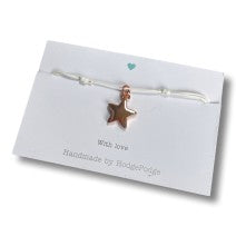 Adjustable cord bracelet with a rose gold star charm