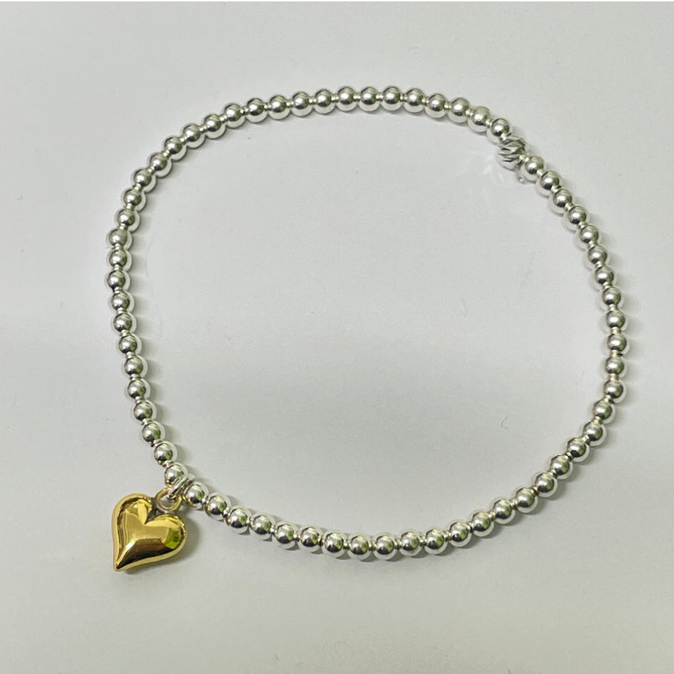 Sterling silver beaded bracelet with gold puff heart charm.