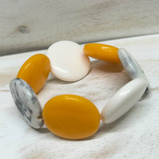 Elasticated resin disc bracelet by Suzie Blue- Yellow, White and smokey grey.