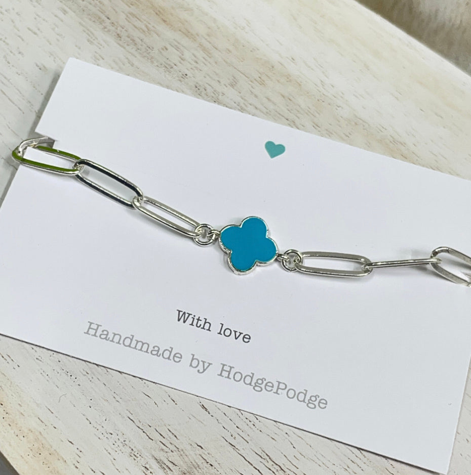 Silver Paperclip chain bracelet with blue clover link charm