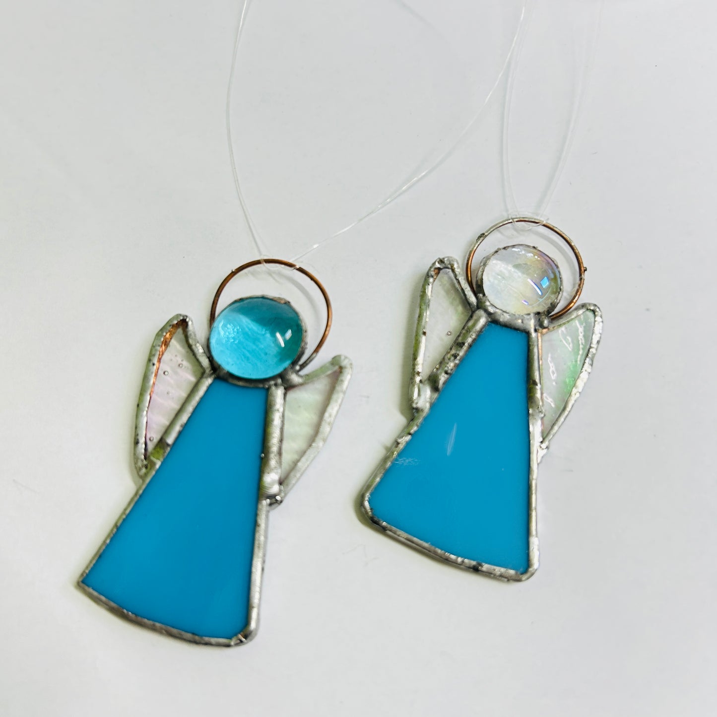 Perc's stained glass guardian angel hanging decoration in blue. Handmade in Norfolk.