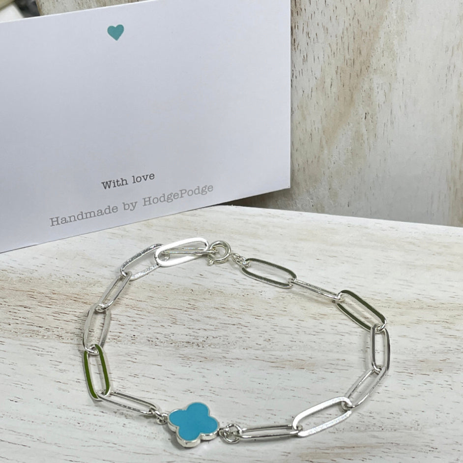 Silver Paperclip chain bracelet with blue clover link charm