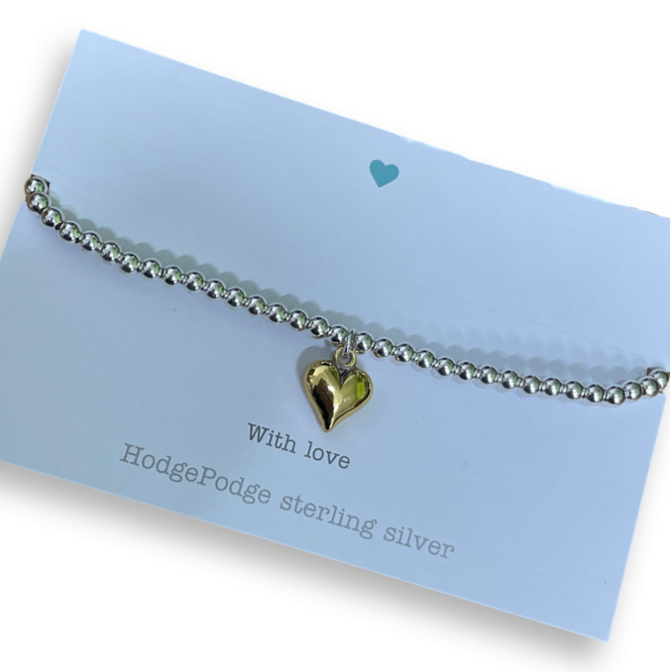 Sterling silver beaded bracelet with gold puff heart charm.