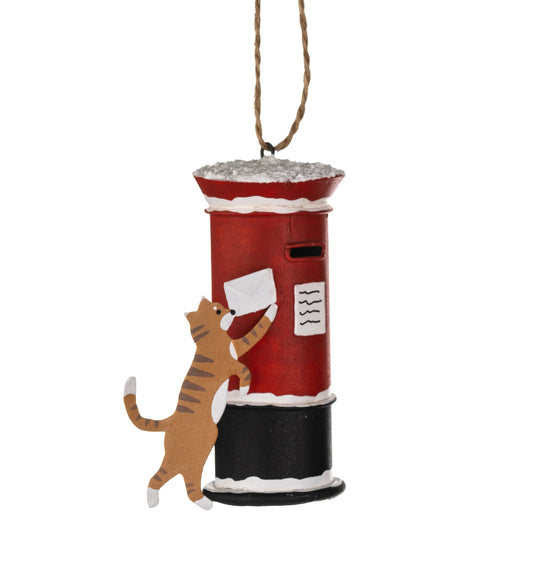 Cat posting a Christmas card hanging Christmas ornament