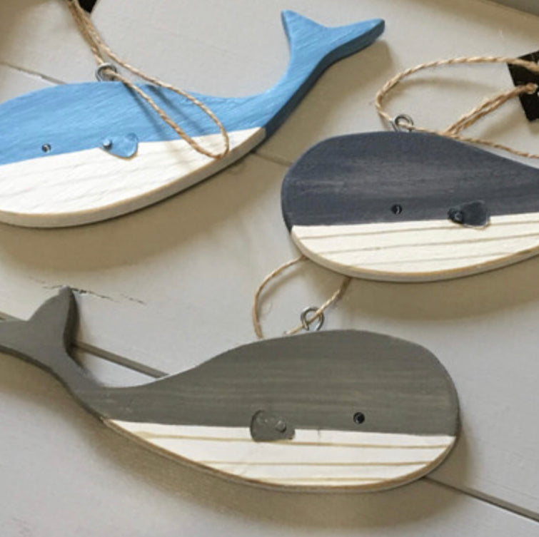 Hanging blue wooden blue whales by Shoeless Joe