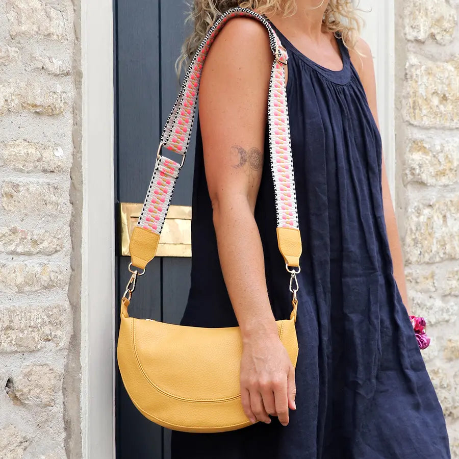 Yellow vegan leather half moon bag with zig-zag strap