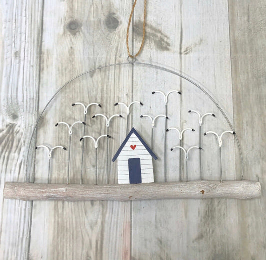 Beach hut with a flock of seagulls on driftwood hanging decoration by Shoeless Joe