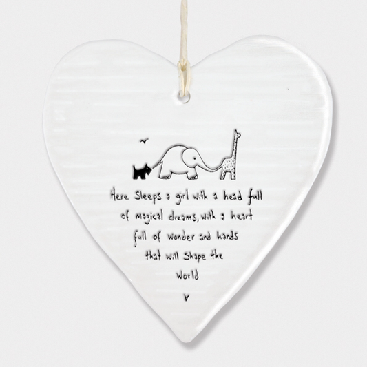 Here sleeps  a girl with a head full of magical dreams , with a heart full of wonderland hands that will shape the world. Hanging porcelain heart by East of India