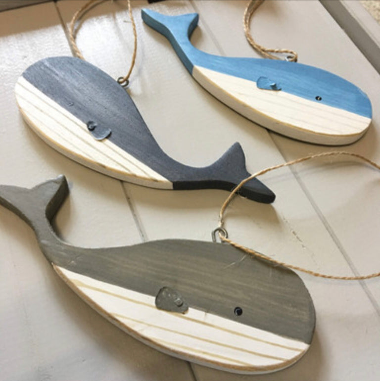 Hanging blue wooden blue whales by Shoeless Joe