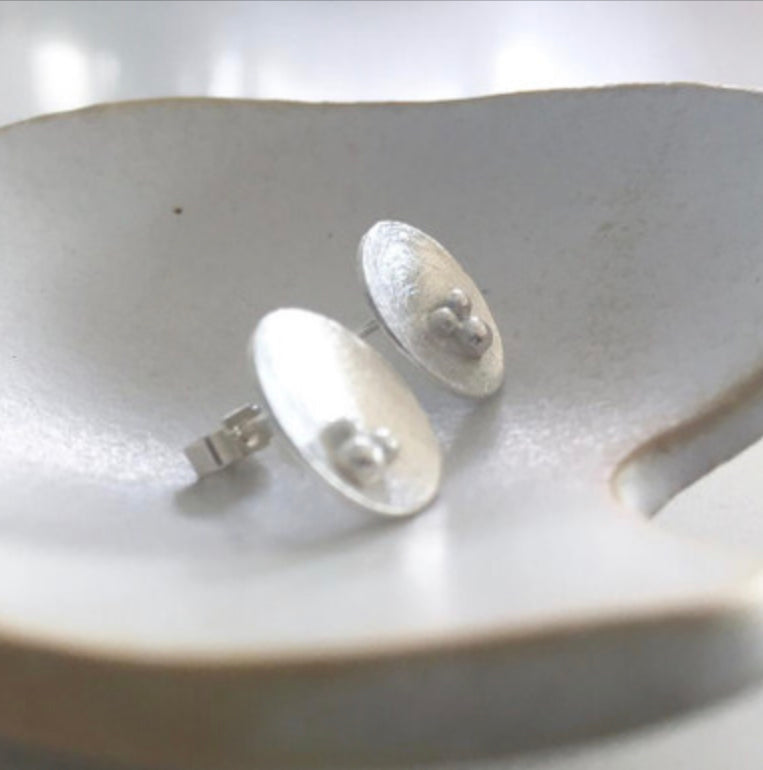 Trio of seeds concave studs by Carmen Palop Design