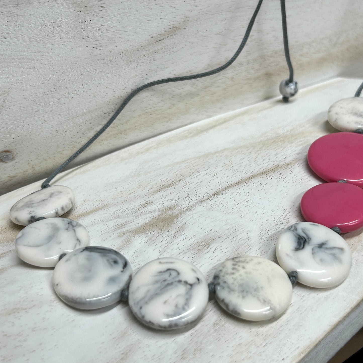 Adjustable cord Smoked resin disc necklace with a pink accent colour