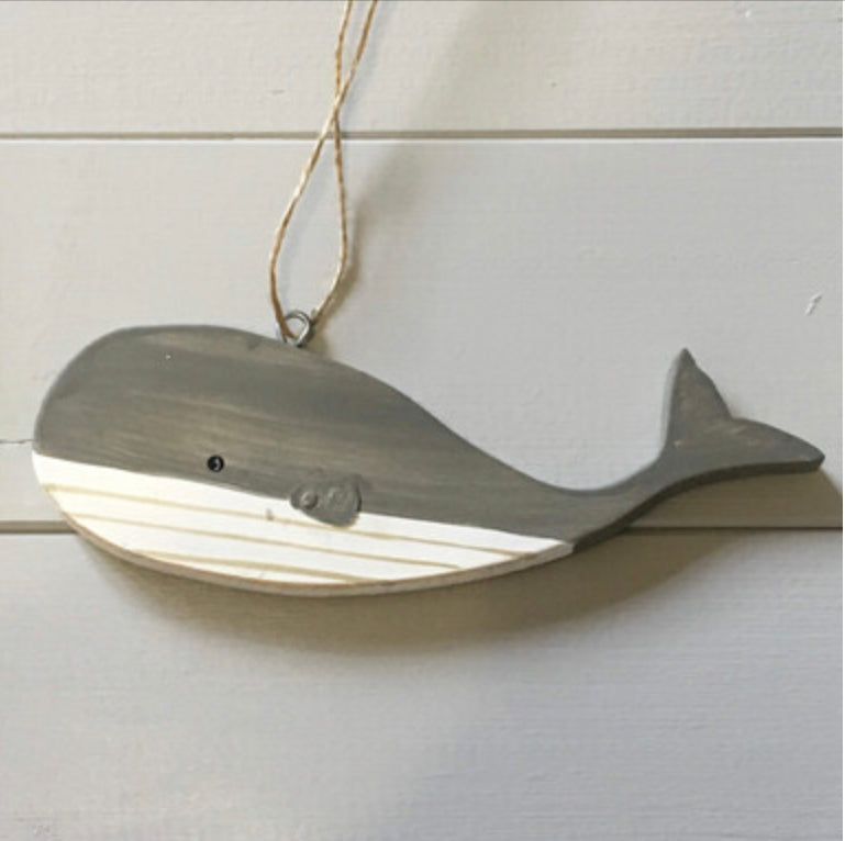 Hanging blue wooden blue whales by Shoeless Joe