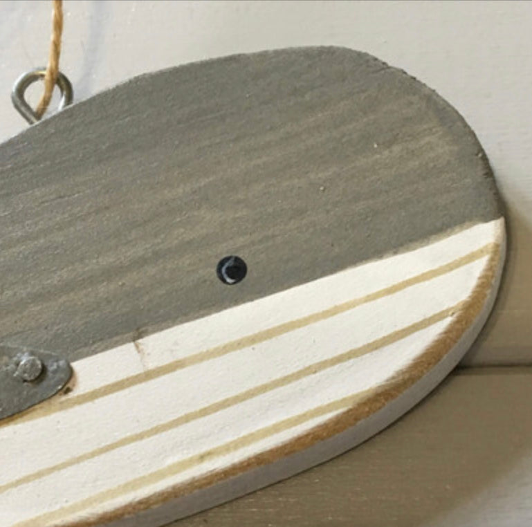Hanging blue wooden blue whales by Shoeless Joe