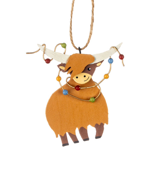 Highland cow with christmas lights hanging decoration