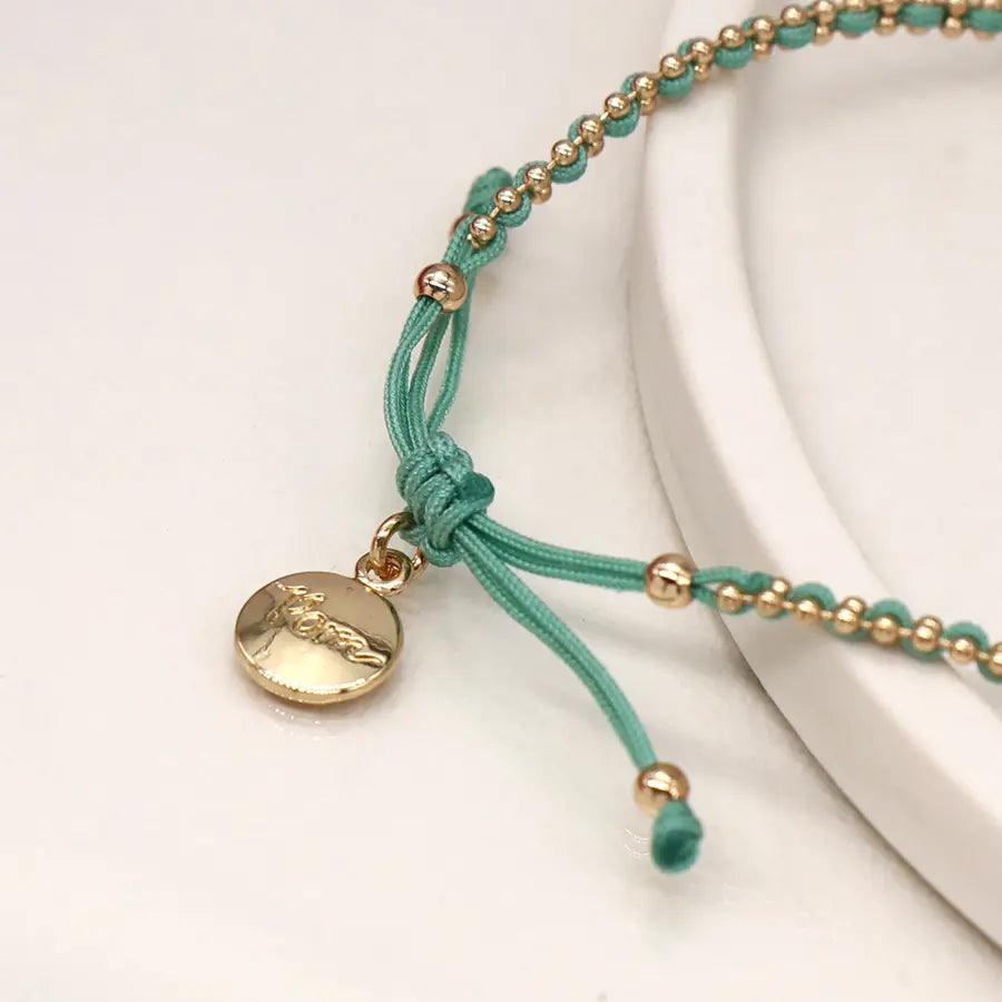 Faux gold bead chain and aqua cord bracelet